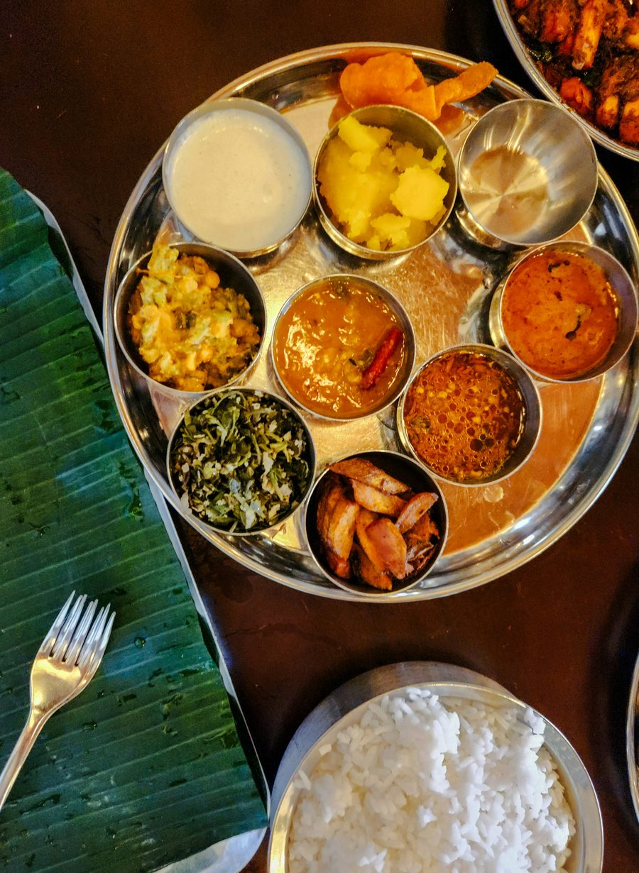 Indian thali with curries, rice and a banana leaf