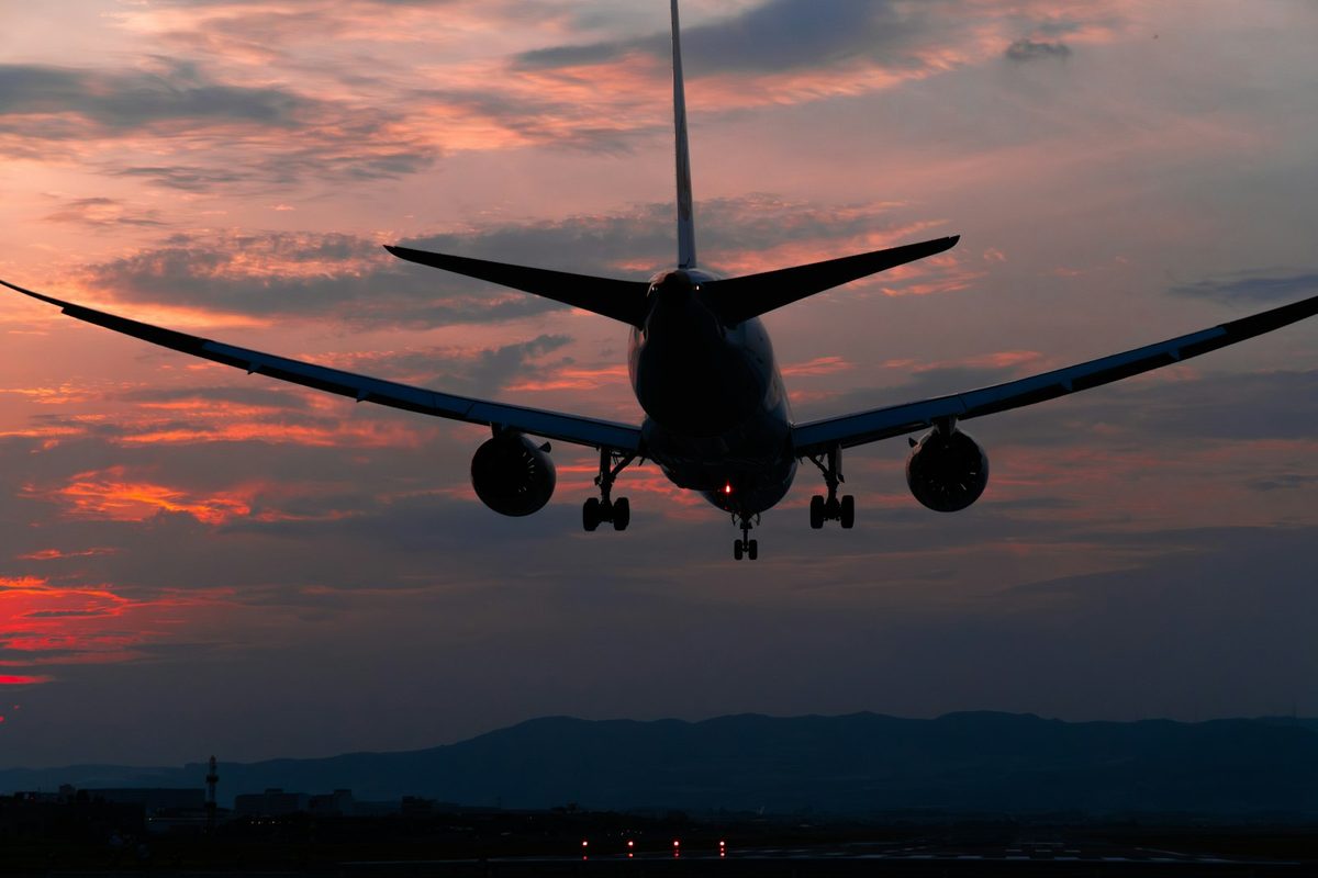 Plane landing at sunset